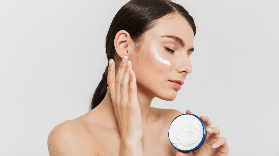 Person applying face cream for a blackhead skincare routine