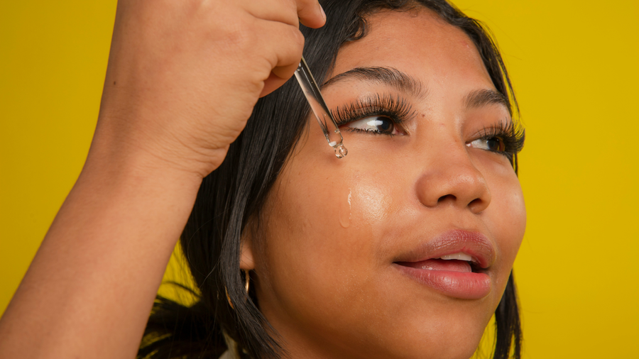 Woman applying Vitamin C serum onto her face