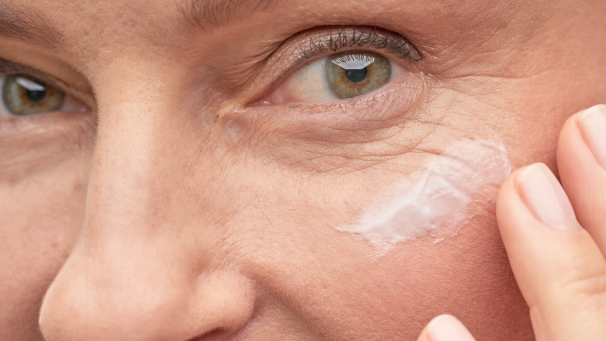 Woman applying anti-aging eye cream
