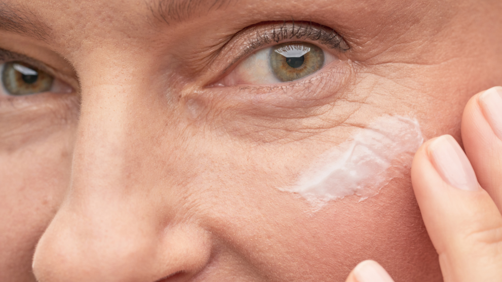 Woman applying anti-aging eye cream