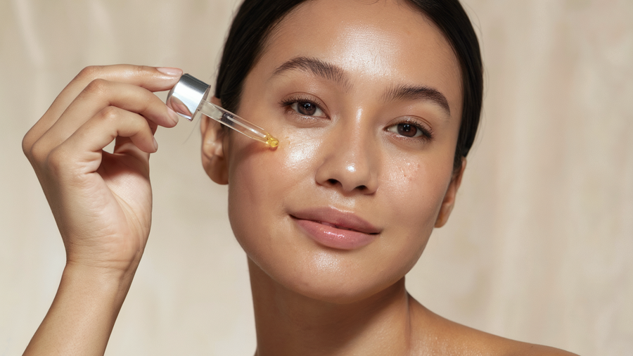 Woman applying anti-aging facial serum
