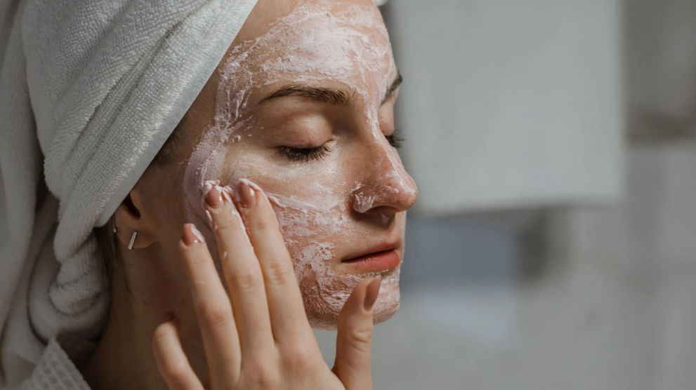 Woman applying facial cleanser to dry skin