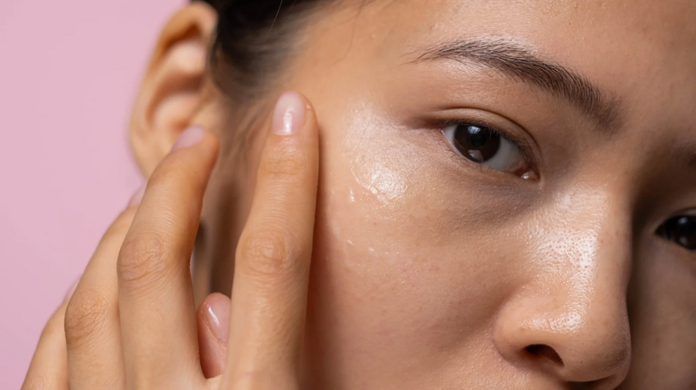 Woman applying moisturizer to facial skin near her eye