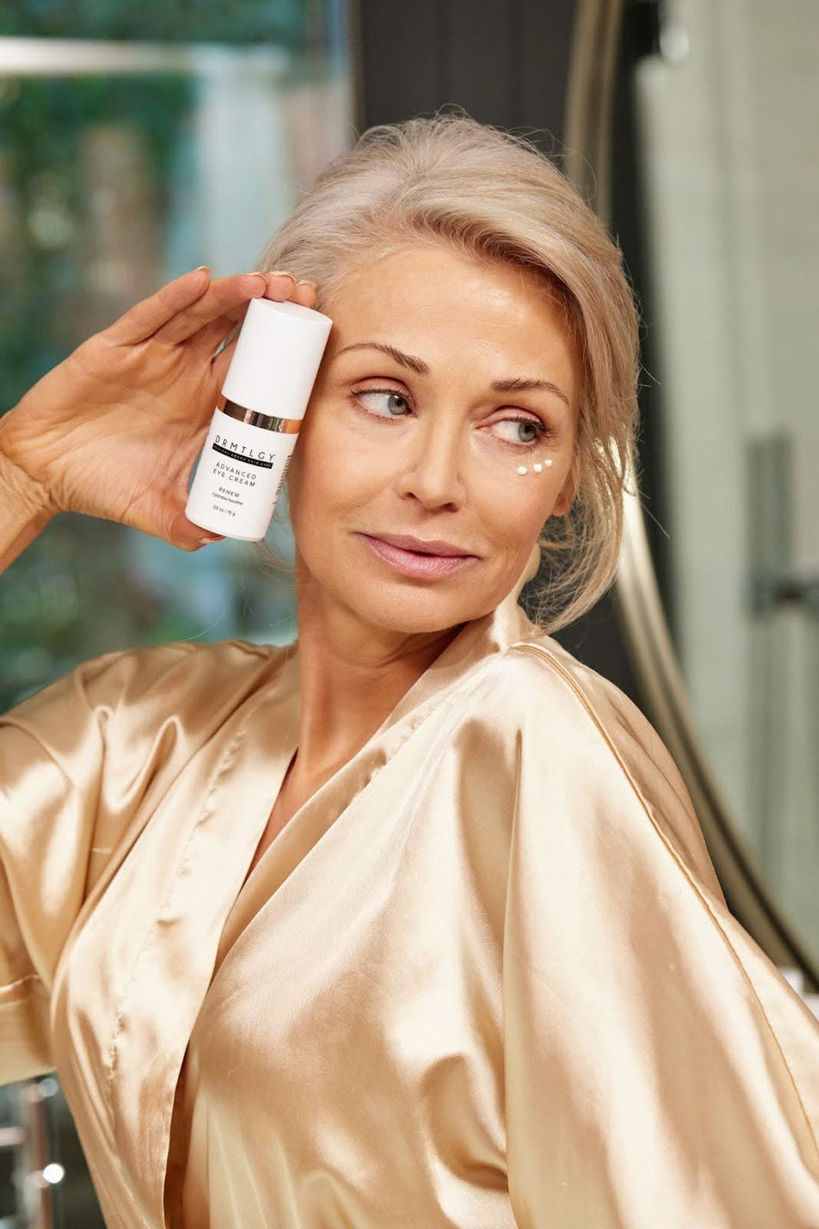 Woman applying under eye cream for dark circles