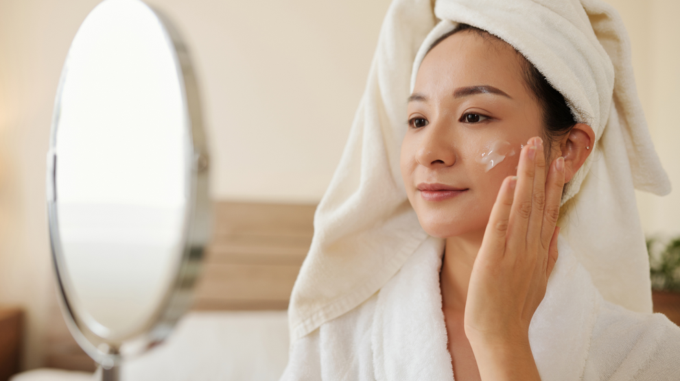 Woman over 40 applying anti-aging cream