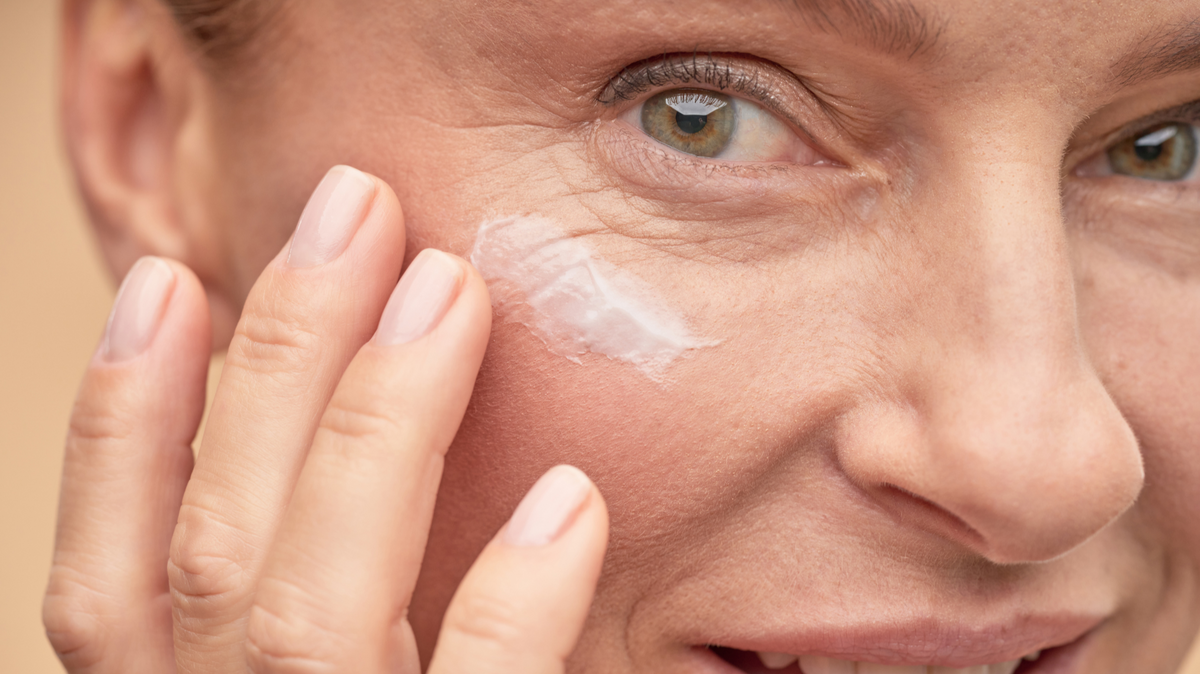 Woman over 60 applying anti-aging eye cream